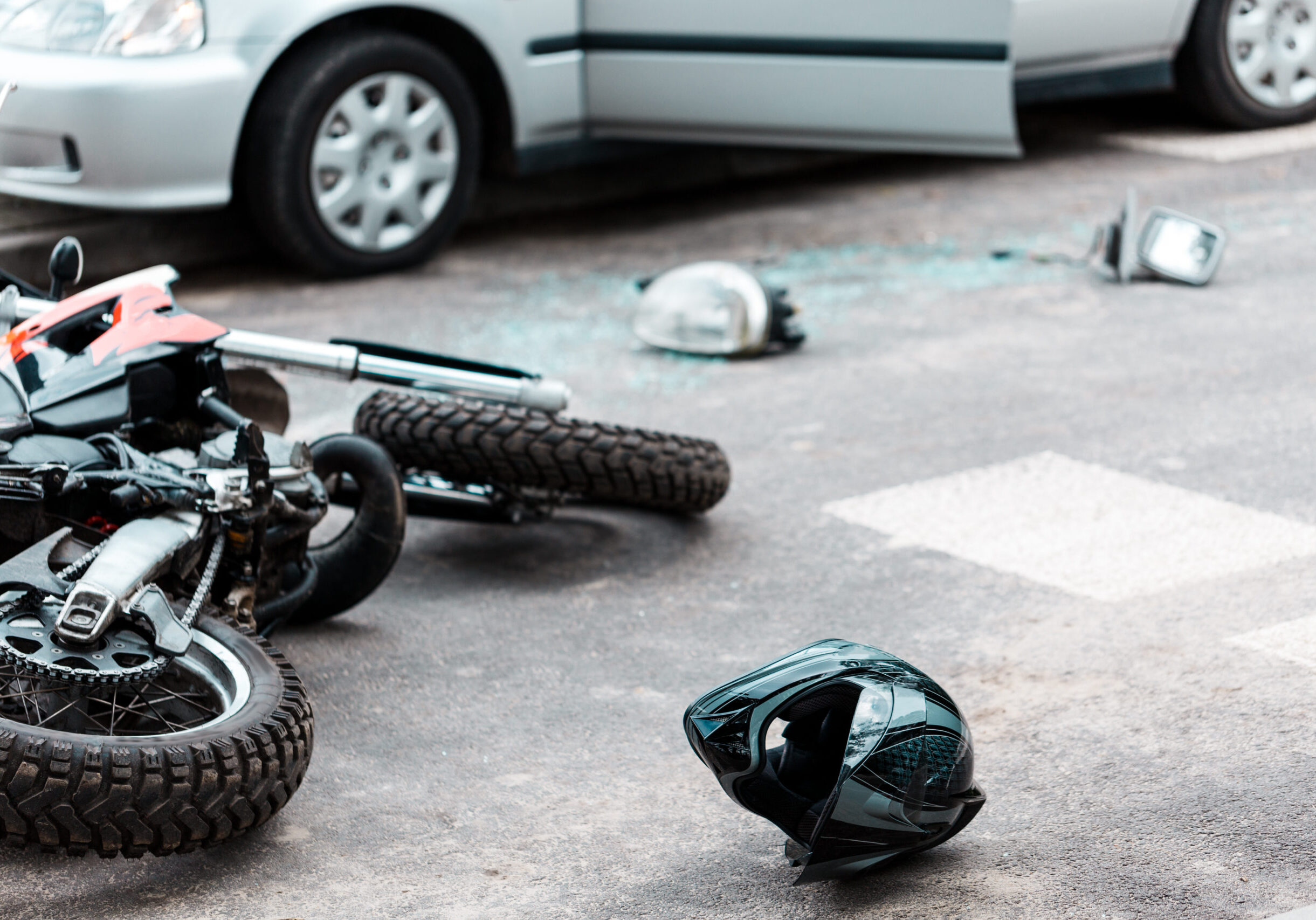 Overturned motorcycle after collision Overturned motorcycle and helmet on the street after collision with the car